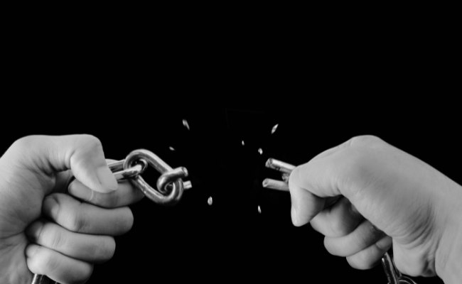 Broken Chains Or Handcuffs Around Money Or Bills: This Symbolizes Being Free From The Burden Of Debt. Debt Protection Insurance