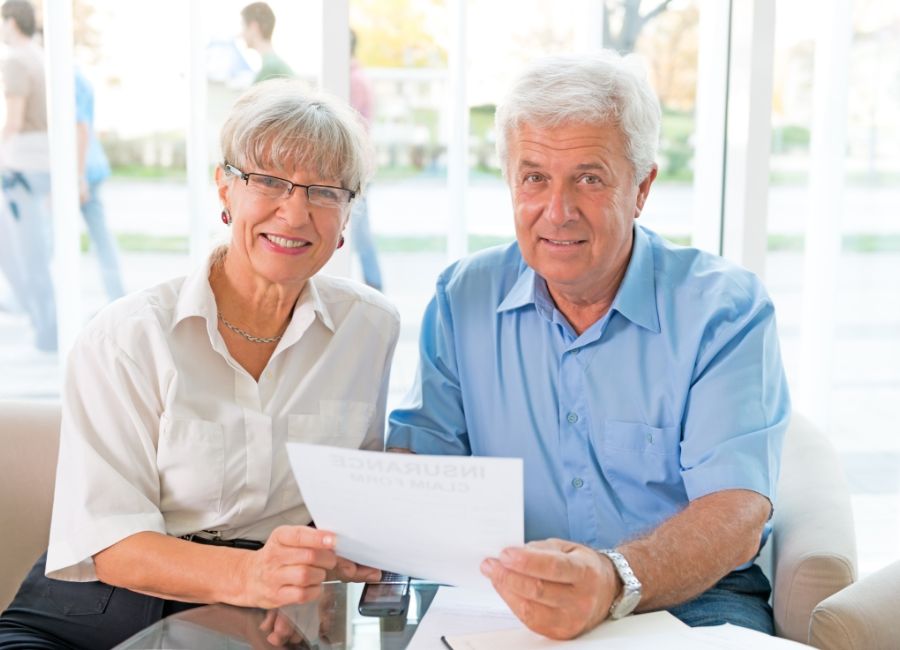 Who Needs Life Insurance? Elderly Couple Having Papper In Hand